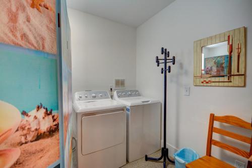 a kitchen with a washing machine and a cross on the wall at Wave To Cool in Surf City
