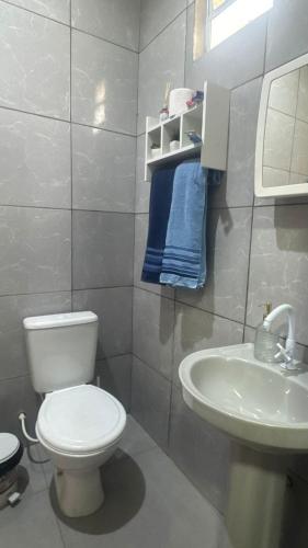 a bathroom with a white toilet and a sink at Casa Borges leal in Santarém