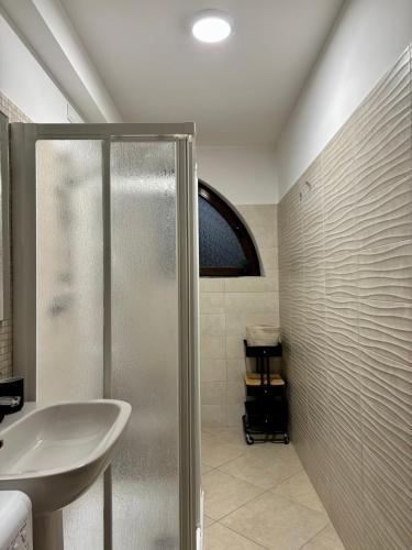 a bathroom with a shower and a sink at Sirè House in LʼAquila