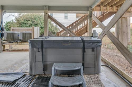 a container with a stool in the middle of a patio at 4110 - Coop's Cottage in Duck