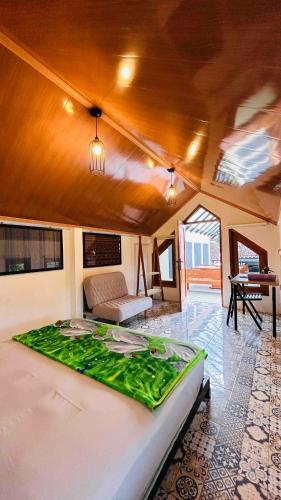 a room with a bed and a couch and a table at Sabi House Sardjono in Yogyakarta