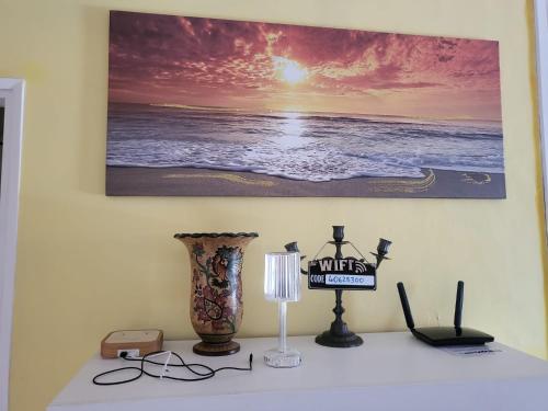 a table with a picture of the ocean on the wall at Residenza Cornicello in Bardolino