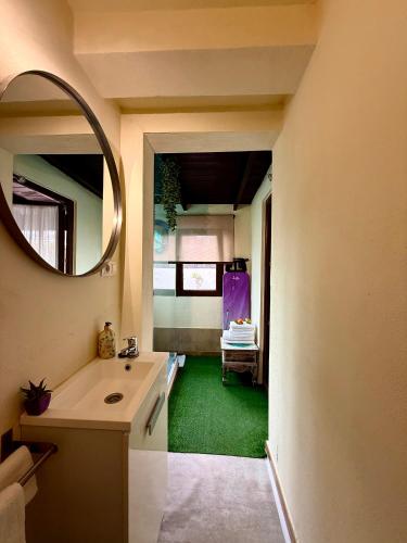 a bathroom with a sink and a mirror at Bungalow Aloha, Piscina Privada, Playa y Barbacoa in Benalmádena
