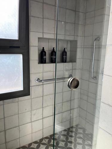 a shower with three bottles on a glass door at Casa Nidito San Javier in San Javier