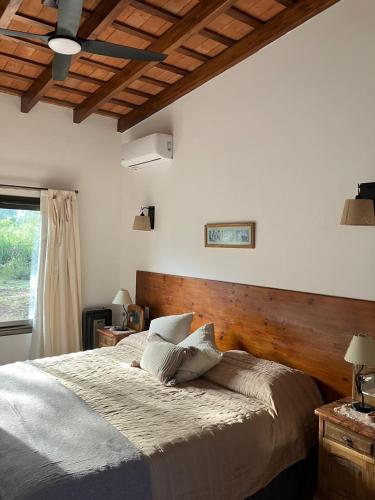 a bedroom with a large bed with a wooden headboard at Casa Nidito San Javier in San Javier