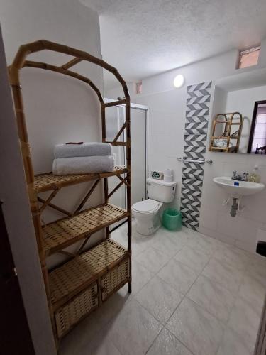 a bathroom with a toilet and a sink at H-OSTELLO LA MERIDIANA in Villa de Leyva