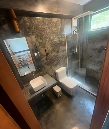 a bathroom with two sinks and a toilet and a mirror at Itacaré Ecolodge - Experiencia de Imersão na Mata Atlântica in Itacaré