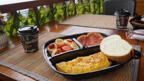 a tray of breakfast food with eggs bread and fruit at Glamping NOVA VILLA EL EDEN in Cali