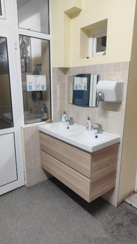 a bathroom with a sink and a mirror at Лидер Хаус хостел in Varna City