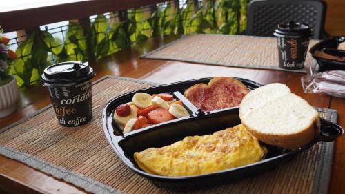 a tray of breakfast food with eggs bread and toast at Glamping DUBÁI VILLA EL EDEN in Cali