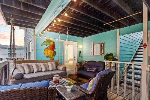 a living room with a couch and a table at Coastal Condo Steps from the Beach in Gulf Shores