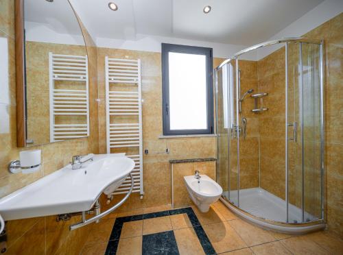 a bathroom with a sink and a shower at CASA MAJOR Hotel & Appartamenti CERVIA in Cervia