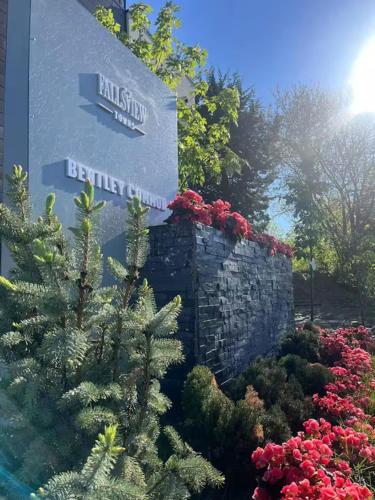 a sign for a building with a christmas tree and flowers at Bentley Commons Fallsview - Luxury 4 Bedroom 4 Bath Townhouse in Niagara Falls