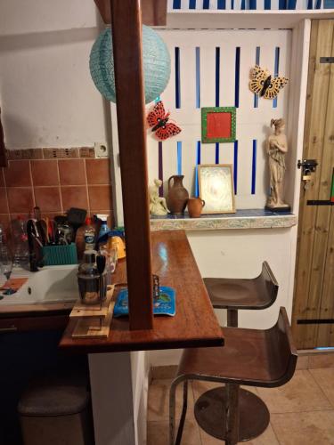 a kitchen with a wooden table and a counter top at Chez Brahim in Pointe-à-Pitre