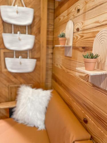 a couch in a room with wooden walls at The Self-Care Tiny Cabin in Parsons
