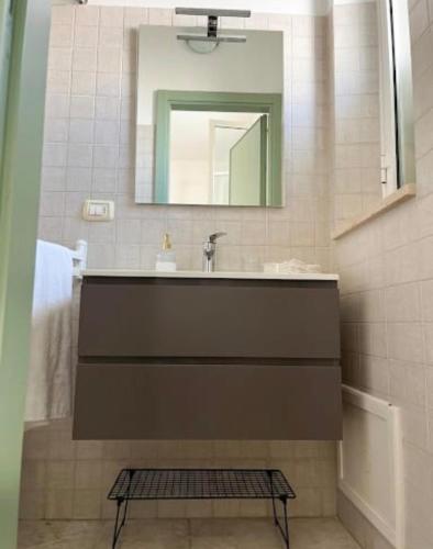 a bathroom with a sink and a mirror at Maison RG in Torre Canne