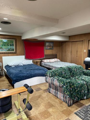 a bedroom with two beds and a couch and a table at Flower Avenue Hosting - Private Suite with De Luxe King Size Bed - 77 per Night 1st guest - 59 2nd guest - 52 each third & 4th guests in Silver Spring