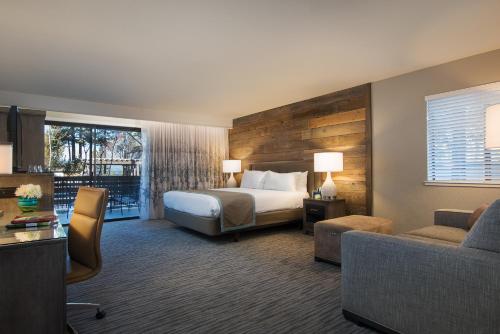 a hotel room with a bed and a couch at Hotel Azure in South Lake Tahoe