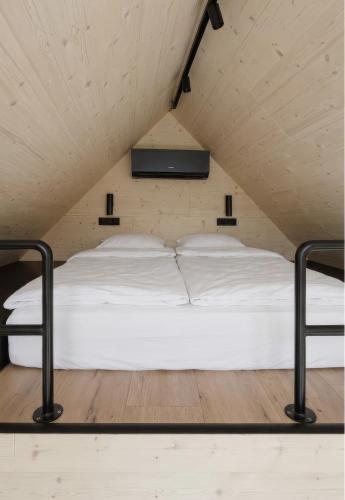 a bedroom with two beds in a attic at Kabiny Kravák in Znojmo