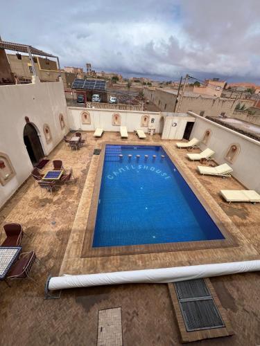 a large swimming pool on top of a building at Riad camels house in Merzouga