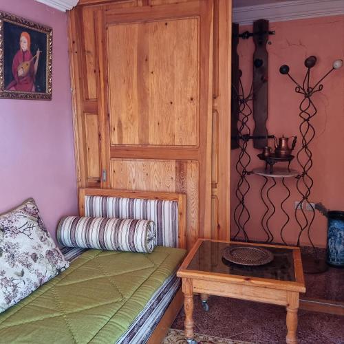 a room with a bed and a table in a room at Momo's villa 2nd room in Aït Ourir
