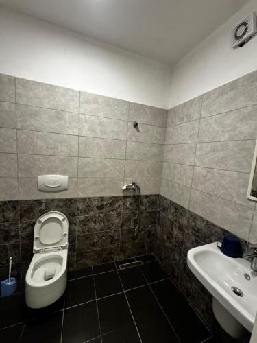 a bathroom with a toilet and a sink at Inis apartamans -50 m from beach in Shëngjin