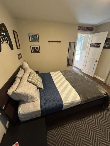 a bedroom with a large bed with a door at Dougs house in Niagara Falls