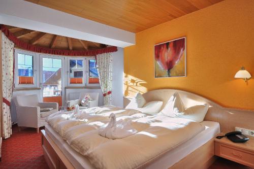 a bedroom with a large bed with birds on it at Die Lilie / Hotel Garni in Reutte