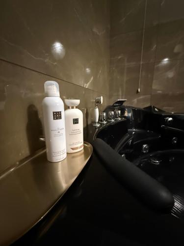 two bottles ofodorizers sitting on a counter in a bathroom at Villa Chamare in Pero