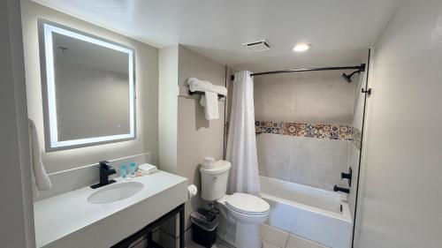 a bathroom with a sink and a toilet and a shower at Rodeway Inn San Diego South San Ysidro Border in San Ysidro