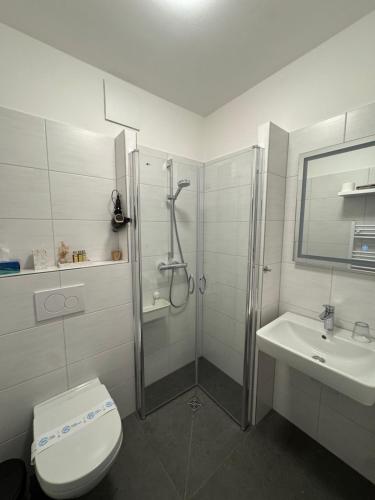 a bathroom with a shower and a toilet and a sink at Medelby Inn in Medelby