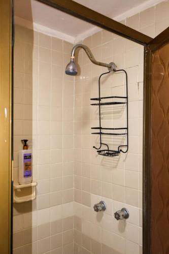 a bathroom with a shower with a sink and a light at Depa 1 sf2 in Hermosillo