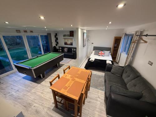 a living room with a couch and a pool table at The Green Bus and the lodge in Woodstock