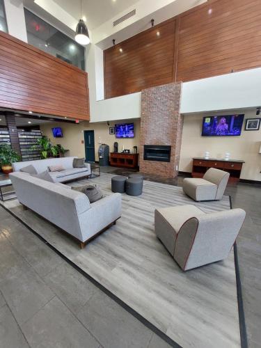 a large lobby with couches and a fireplace at Surface Hotel OKC in Oklahoma City