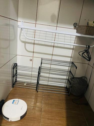 a bathroom with a toilet sitting on a wooden floor at Kit luxo com spa aquecido in Florianópolis