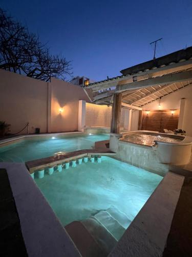 a swimming pool in the backyard of a house at night at CASA con alberca, súper ubicación. Puerto de Veracruz in Veracruz