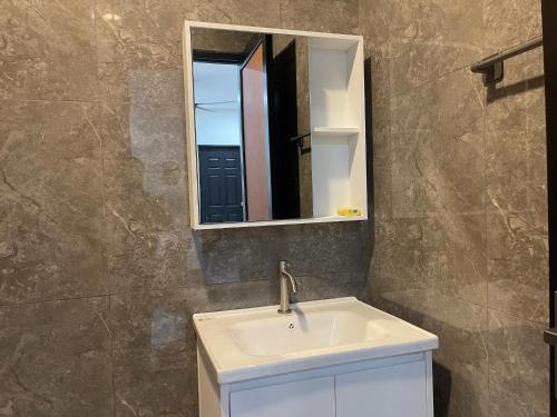 a bathroom with a sink and a mirror at The Bunker StudioStay in Arau