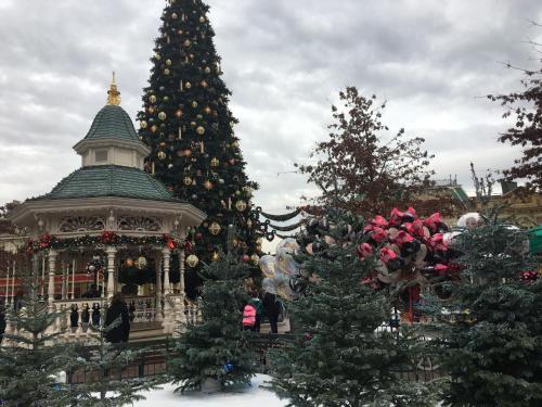 a christmas tree and a gazebo with christmas trees at F&B's Home Disneyland Paris in Serris