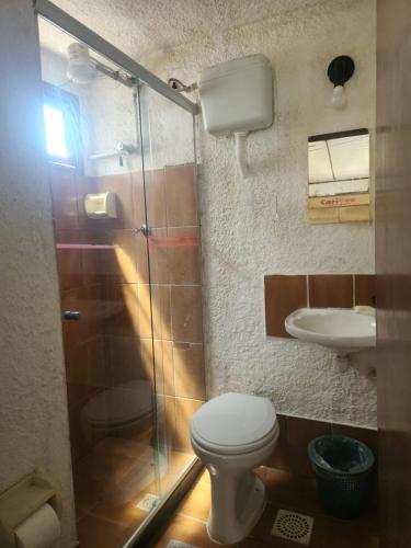 a bathroom with a toilet and a sink at Solemar in Guarapari