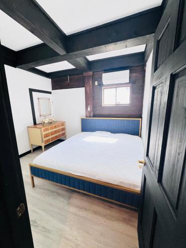 a bedroom with a bed and a wooden door at Beautiful cabin surrounded by nature in Catskill