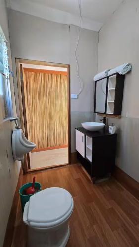 a bathroom with a toilet and a sink at Uros Sunset Lodge in Puno