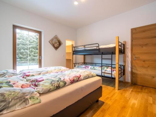 a bedroom with two bunk beds and a window at Haus Bergblick in Westendorf