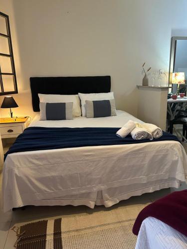 a bedroom with a large bed with pillows on it at Vila Noel Centro in Penedo