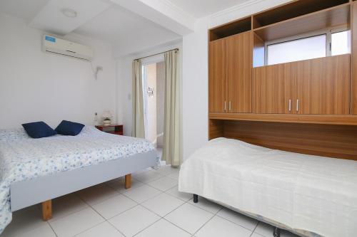 a bedroom with two beds and a large cabinet at Dpto M1 con cochera centro-sur Santa Fe in Santa Fe