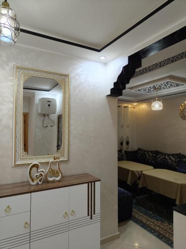 a room with a mirror on the wall and a bed at Khouribga in Khouribga