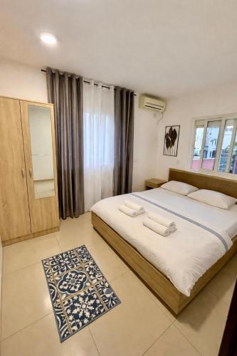 a bedroom with a large bed and a rug at Guest house, Small beach in Ulcinj