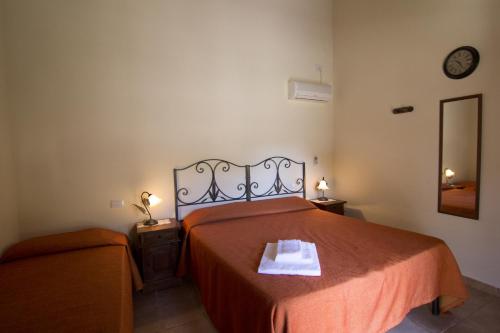 Postel nebo postele na pokoji v ubytování Agriturismo Sa Rocca