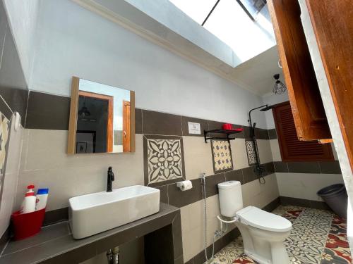 a bathroom with a sink and a toilet at Sabi House Kates in Timuran