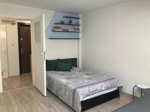 a small bedroom with a bed in a room at Cozy loft apartment in Pleven