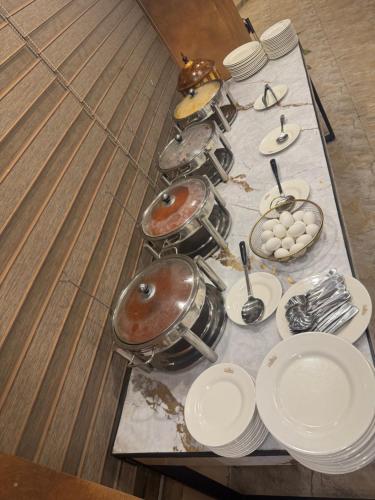 a table with plates and dishes on it at Al Makkah Hotel in Karachi